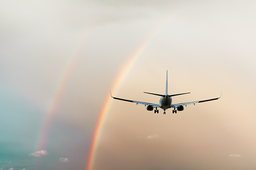 Commercial airplane and beautiful rainbow in the sky