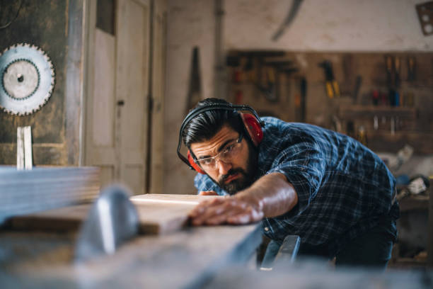 istock Carpenter cutting wooden plank 1070000590