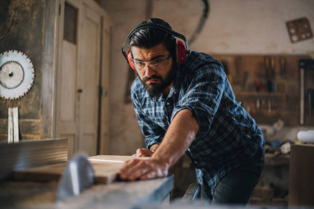istock Carpenter cutting wooden plank 1070000606