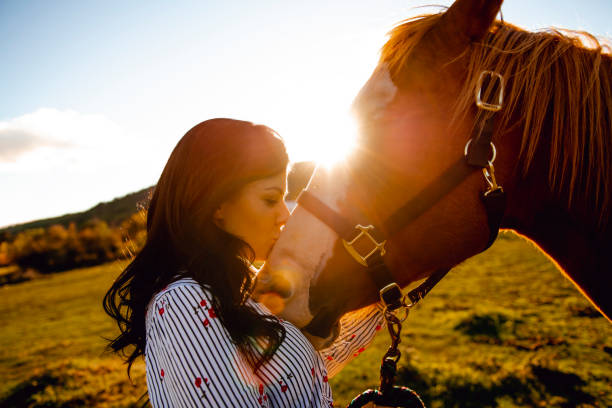 istock A Woman with her horse at sunset, autumn outdoors scene 1070000708