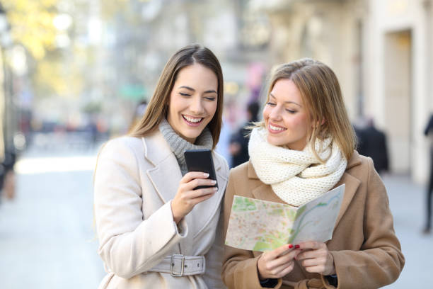 istock Tourists comparing phone and map in winter holiday 1070000724