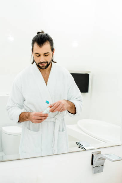 istock handsome adult man preparing for brushing teeth in bathroom 1070001986