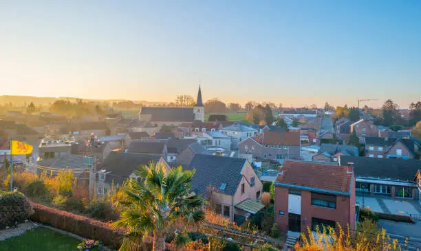 Photo of Ancient church in a village on a hill below a blue sky at sunrise at fall