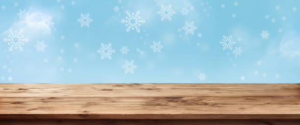 istock Blue snowflakes background with wooden table 1070003222
