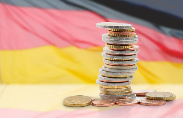 the economy of this country Coins stacked on each other in different positions with Germany flag german flag photos stock pictures, royalty-free photos & images