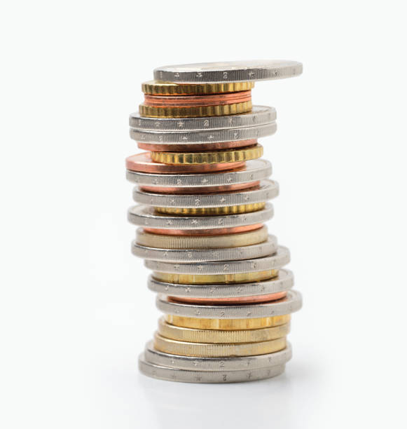 domestic economy Many coins in column isolated on white european union coin photos stock pictures, royalty-free photos & images