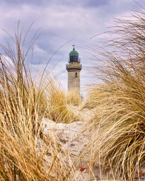 Lighthouse between dune grass. Rostock, Germany Lighthouse between dune grass. Rostock, Germany rostock photos stock pictures, royalty-free photos & images