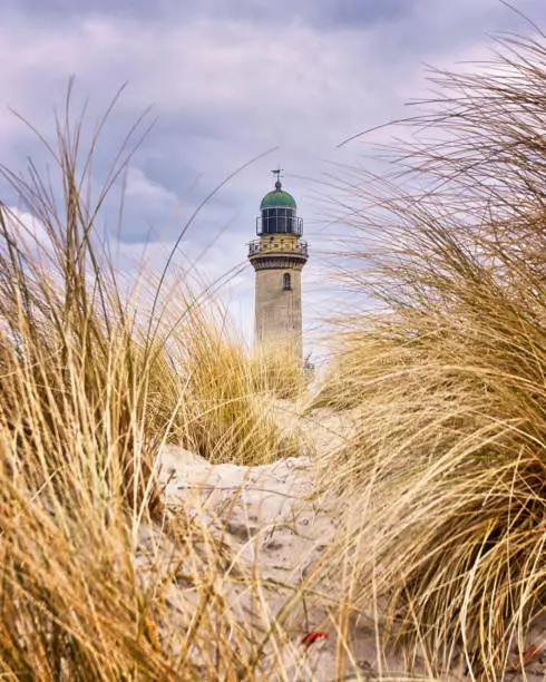 Lighthouse between dune grass. Rostock, Germany