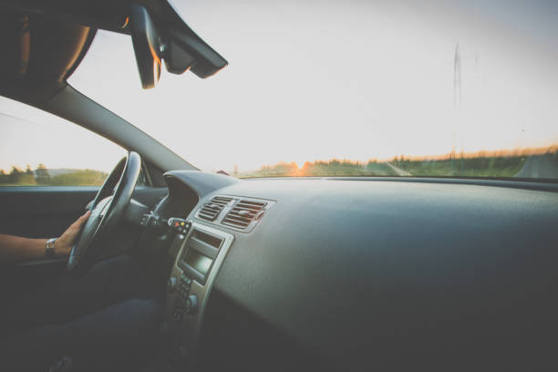 istock Man driving a car moving fast on a highway 1070005598