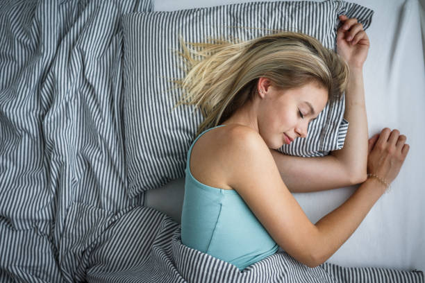 istock Beautiful young woman sleeping in bed 1070005600