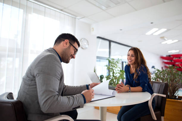 istock Job interview. Employer reading CV while candidate is smiling. Candidate selection for employment. 1070006272
