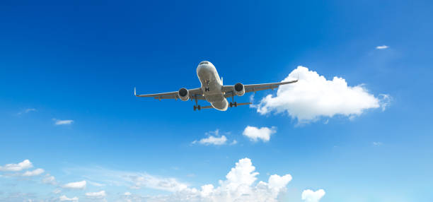 istock Airplane flying in the blue sky 1070013378