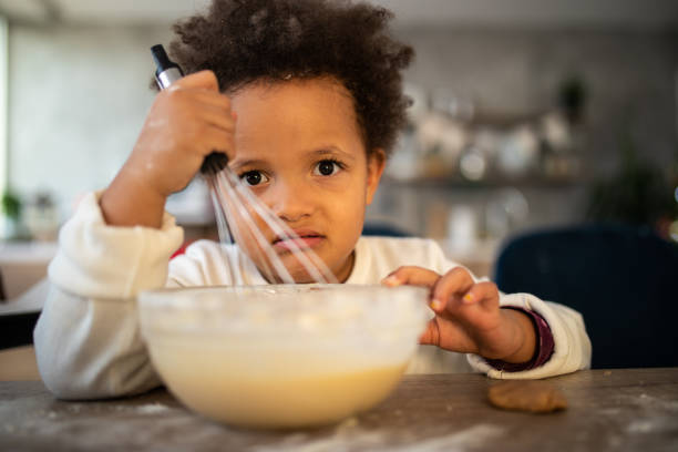 istock Confused girl mixing with egg beater 1070015180