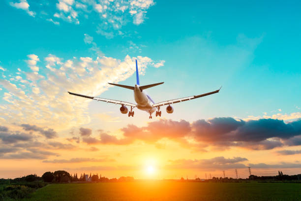 istock Airplane in the sky at sunrise 1070021484