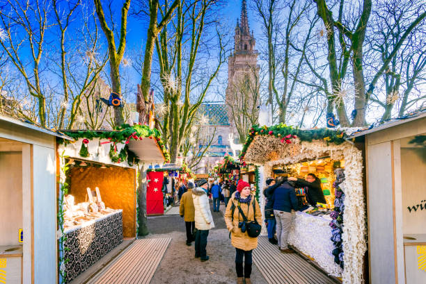 Basel, Switzerland - December 2017. Christmas fairytale market at Munsterplatz and Munster Cathedral, Swiss Confederation.