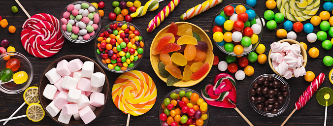 Assorted colorful candies background, top view, copy space