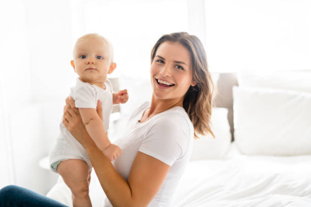 istock mother with baby on bed having good time 1070025482