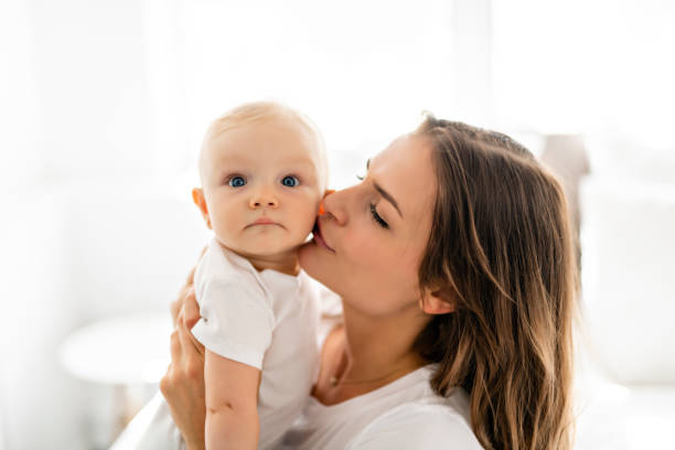 istock mother with baby on bed having good time 1070025780