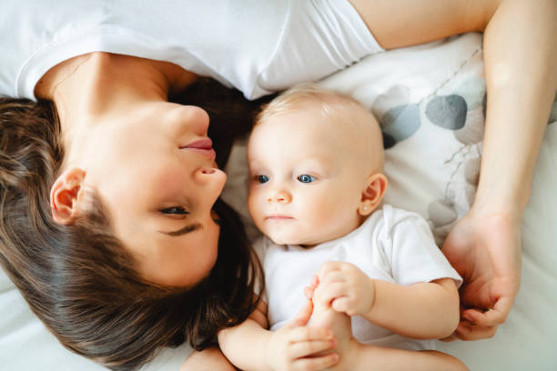 istock mother with baby on bed having good time 1070026406