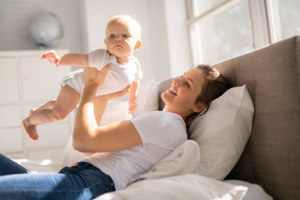 istock mother with baby on bed having good time 1070026410