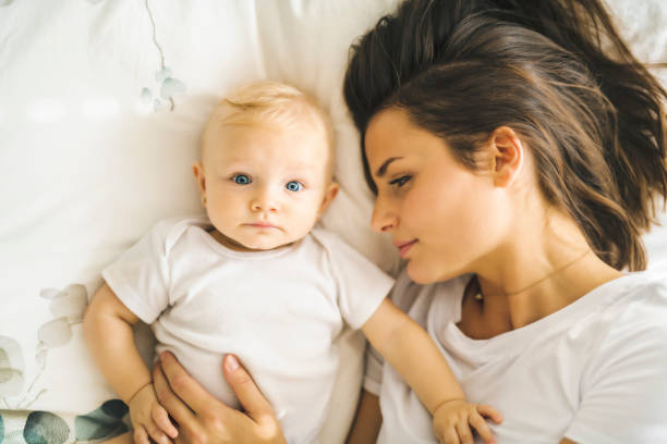 istock mother with baby on bed having good time 1070026932