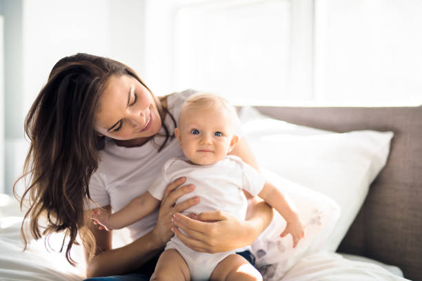 istock mother with baby on bed having good time 1070027332