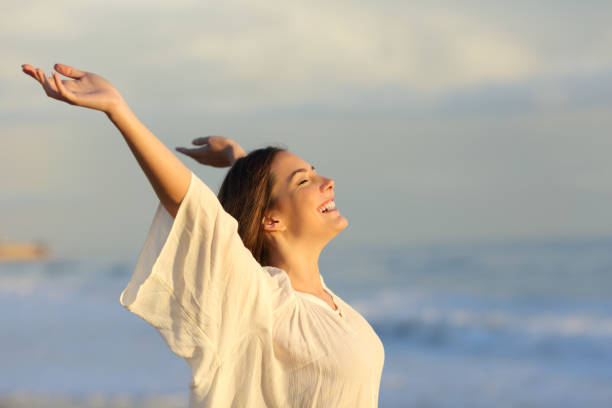 istock Joyful woman enjoying a day on the beach 1070030084