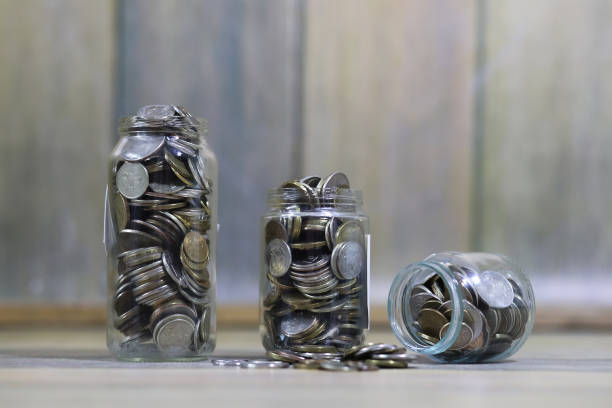 istock Accumulated coins stacked in glass jars 1070032918
