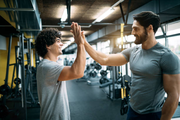 istock Men high fiving at the modern gym 1070034946