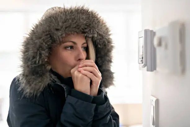 Photo of Woman With Warm Clothing Feeling The Cold Inside House