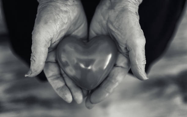 istock elder woman holding heart 1070035664