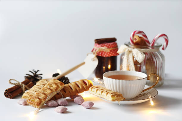 istock Tea with pastries for breakfast. Sweets and pastries with nuts for tea on a white background. A coffee cup and patties. 1070039496