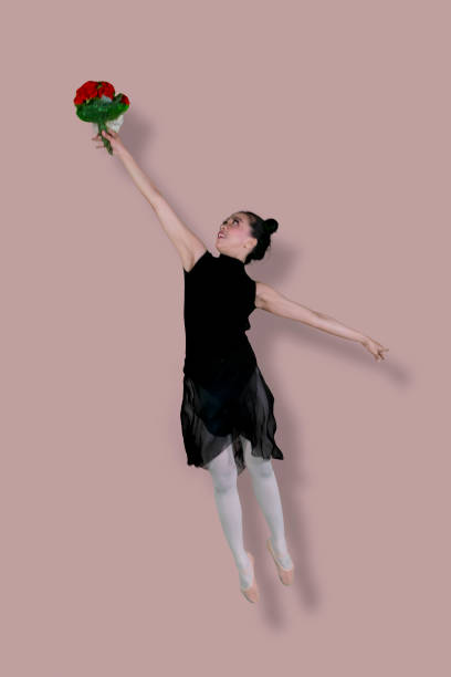 istock Female ballet dancer is dancing with flowers 1070043148