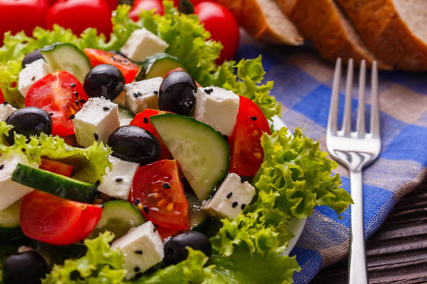 istock Greek salad on a wooden rustic background 1070043214