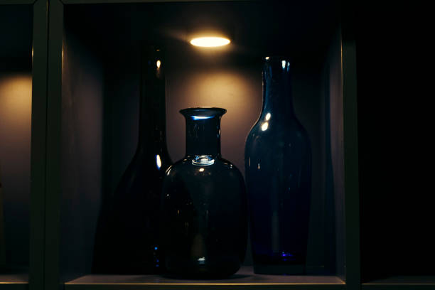 istock Close-Up Of Bottles In Illuminated Shelf 1070045190