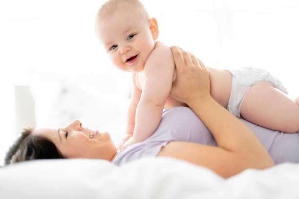 istock Mother lay on bed with his baby 1070045488