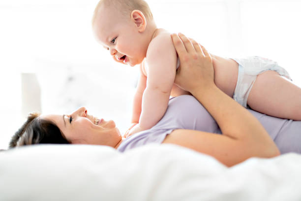 istock Mother lay on bed with his baby 1070045490
