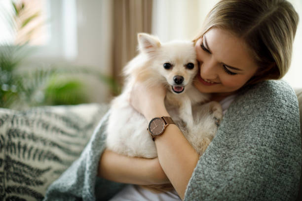 istock Woman cuddling with her dog 1070045684
