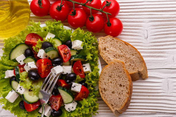 istock Greek salad on a wooden rustic background 1070045856