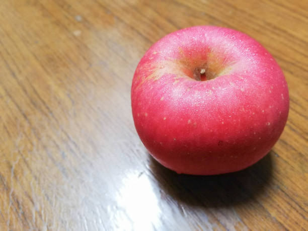 Red apple on wooden background