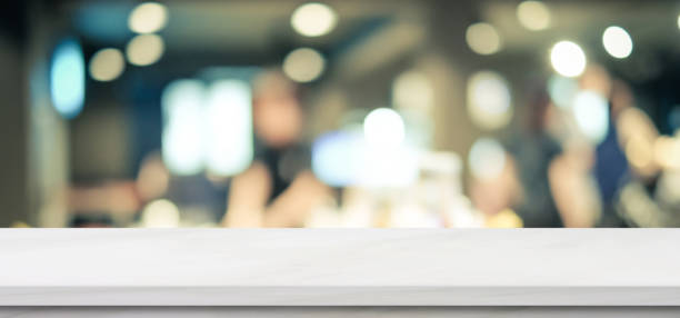 istock Empty white marble table over blur restaurant background, product and food display montage 1070046914