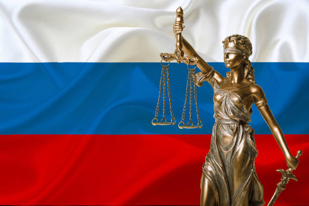 istock statue of justice and russia flag 1070047772