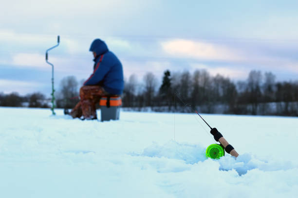 istock Little winter fishing rod ice 1070052694