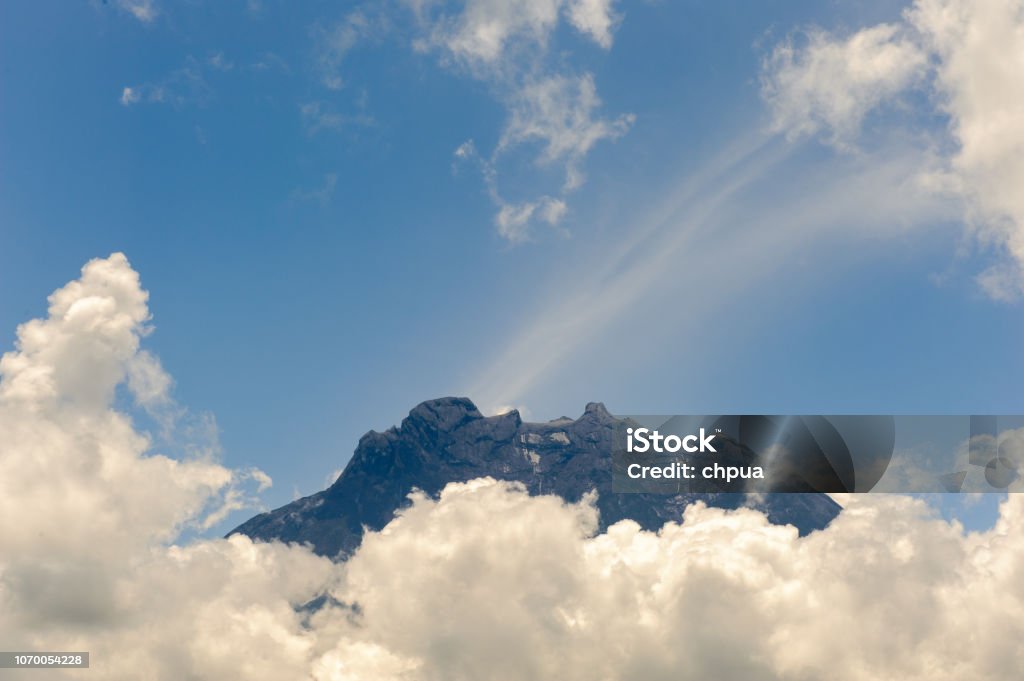 View of Mt Kota Kinabalu surrounded with clouds Adventure Stock Photo