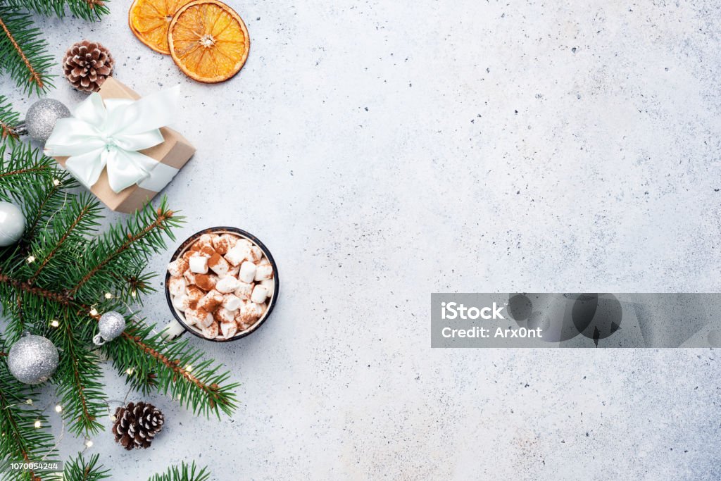 Fir tree, gift box and hot chocolate. Christmas background Fir tree, gift box and hot chocolate. Christmas background. Winter holidays background with copy space for text. Flat lay Vacations Stock Photo