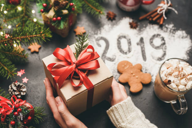 Christmas or New Year 2019 Hands Holding Gift Box Christmas or New Year 2019 Hands Holding Gift Box. Happy New Year or Merry Christmas concept, Winter Holidays Background new year 2019 stock pictures, royalty-free photos & images