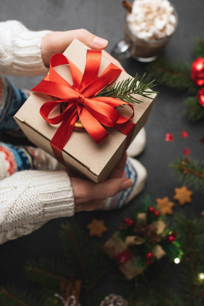 istock Person holding Christmas present gift box 1070054422