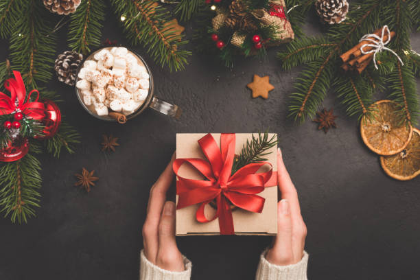istock Christmas gift box in craft paper with red ribbon 1070054430