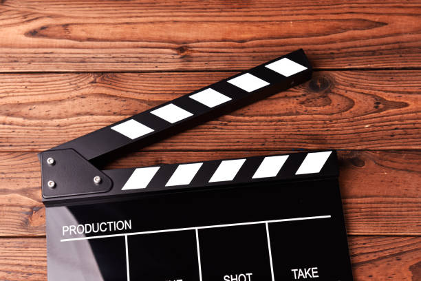istock Movie clapper board on wooden background 1070057510