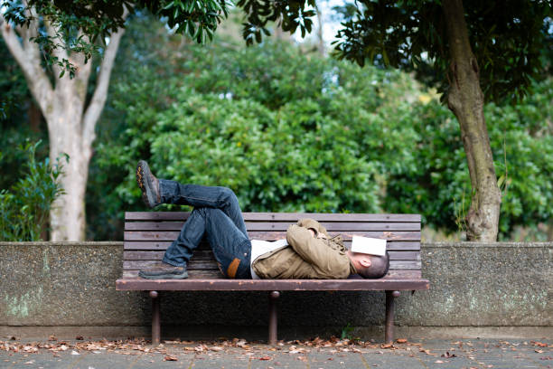 istock Men take a nap on a bench in the park 1070058988